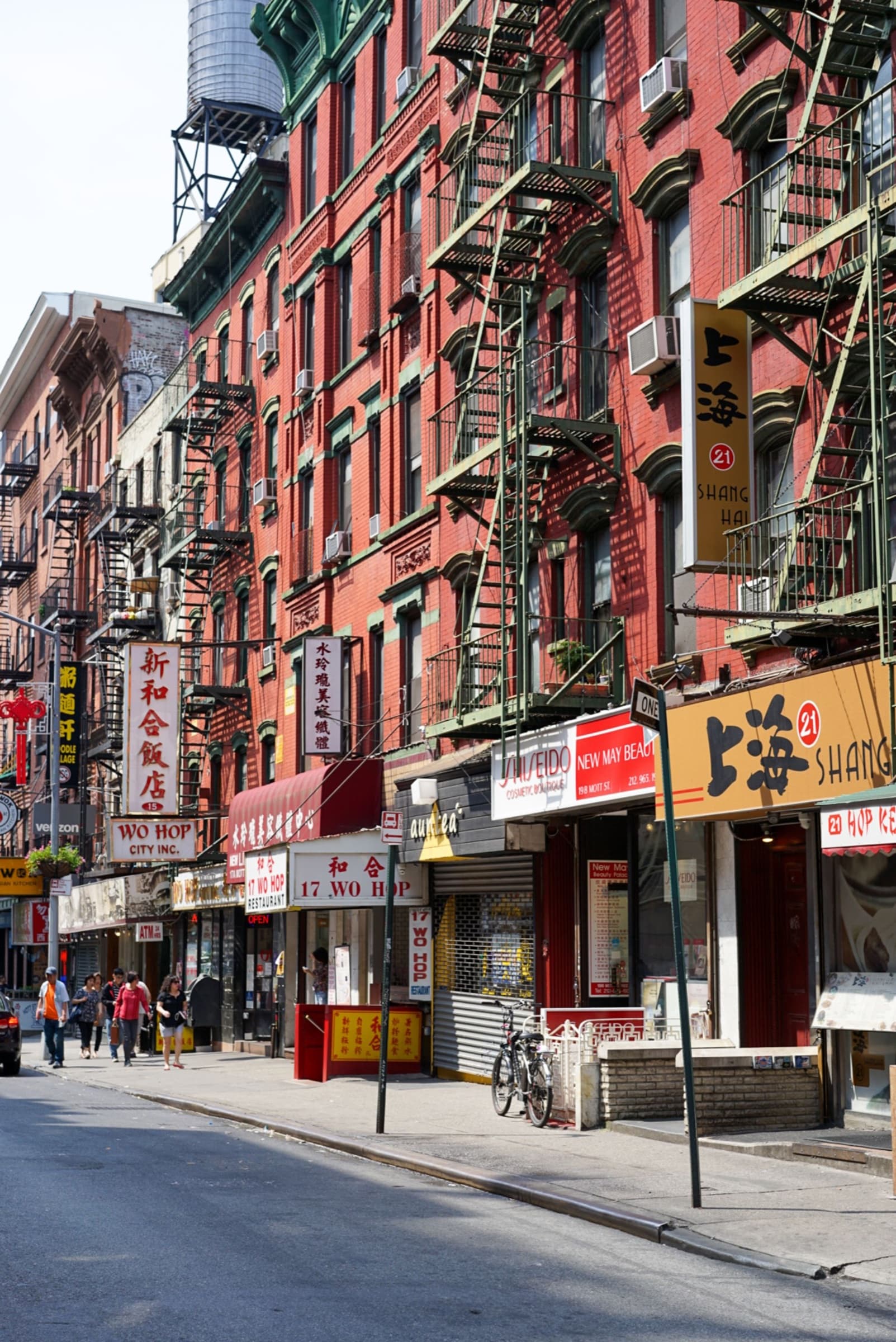 Historic storefronts and pedestrians in Chinatown, New York City