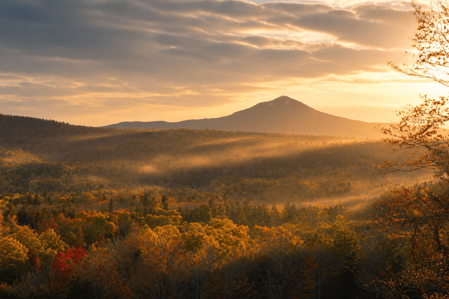 Golden evening light and mist across autumn mountains in New York State